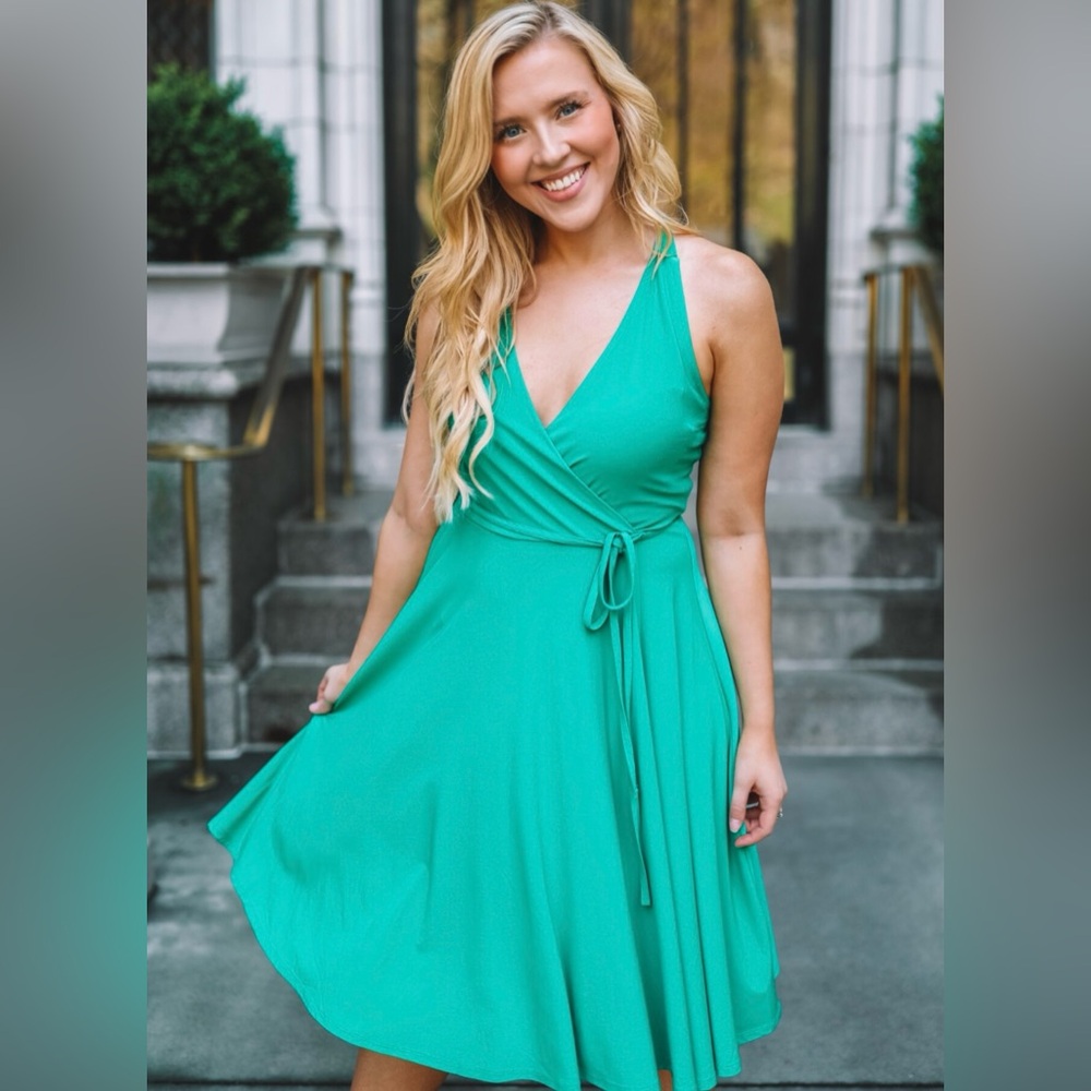 Ashley Graham beyond emerald green, faux wrapped dress